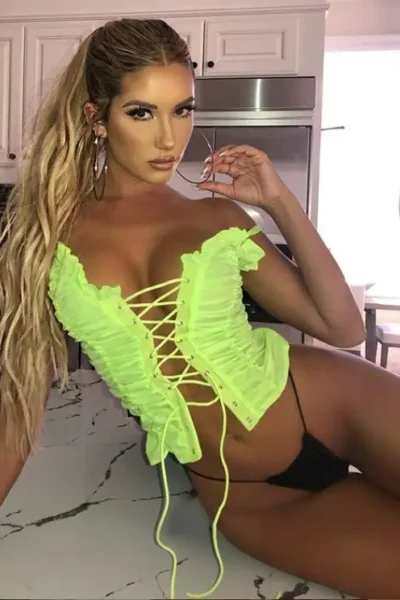 Sara, sexy Amsterdam escort in a yellow corset