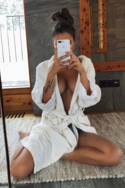 brunette escort Amsterdam Valentina white robe mirror selfie soft light natural beauty relaxed mood
