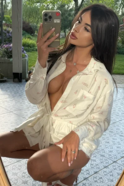 Daniela in white lingerie posing in a luxury setting in Amsterdam