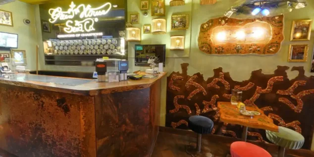 Inside Green House Coffeeshop Amsterdam – Cozy Interior with Award-Winning Atmosphere
